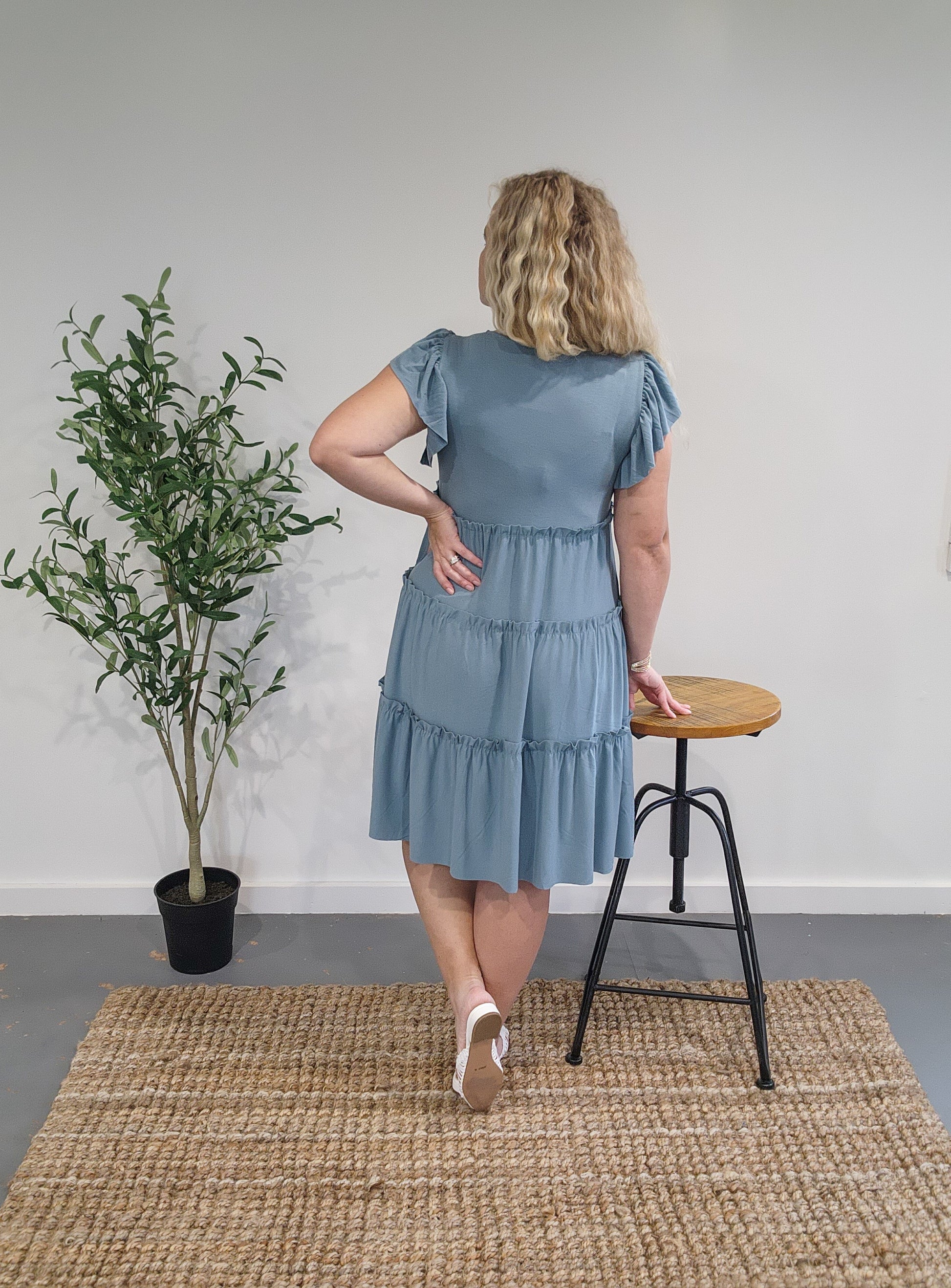 Back view of the ruffle sleeve tiered dress in blue grey