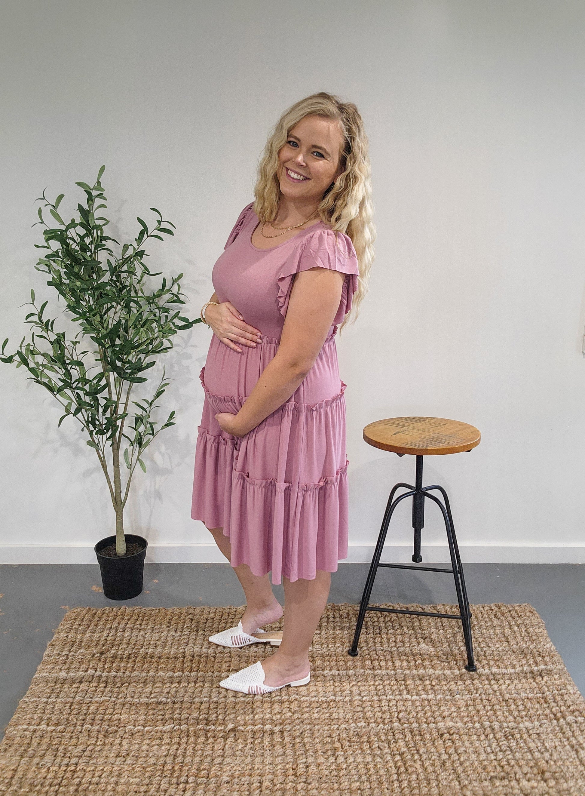 Side view of the ruffle sleeve tiered dress in light rose showing it is maternity friendly