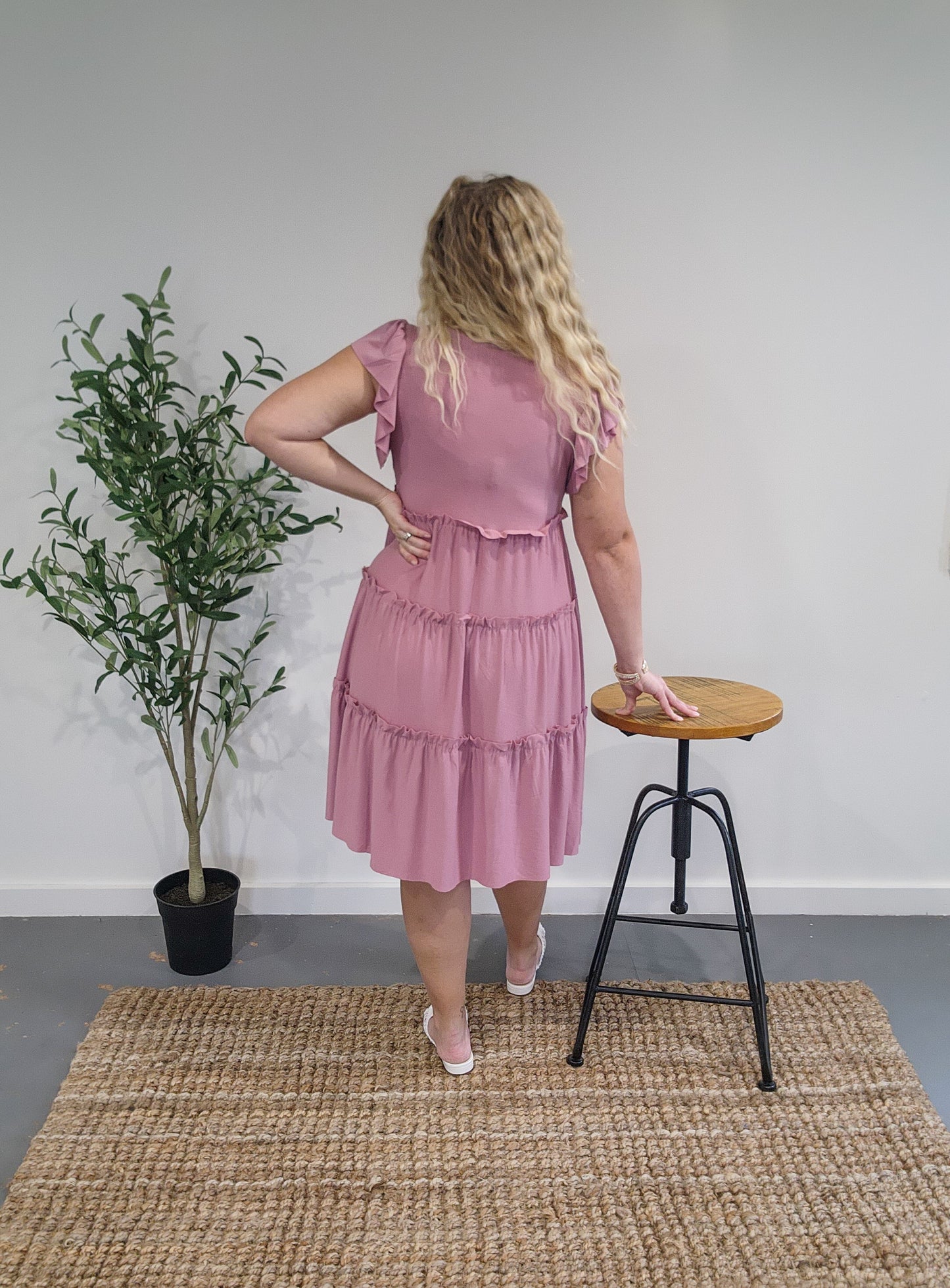 Back view of the ruffle sleeve tiered dress in light rose